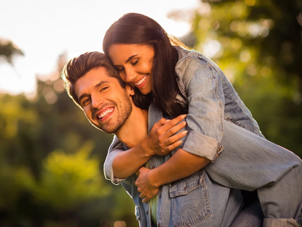 Young couple smiling together with bright, white teeth